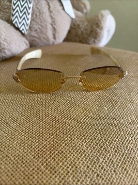 Rimless Gold Sunglasses with Amber Lenses… diamond crusted alligator w/ruby eye